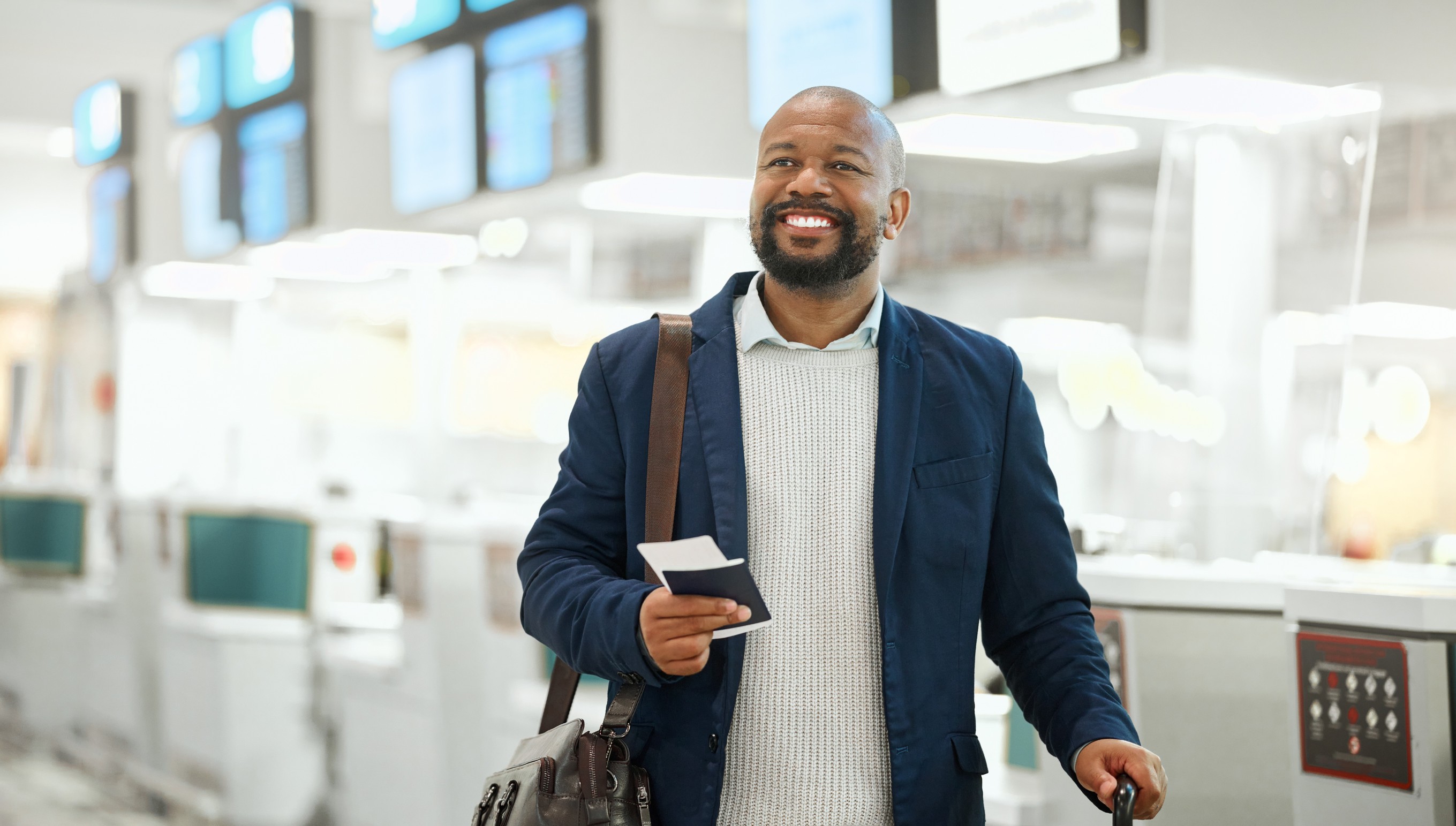 African Businessman Ticket And Luggage At Airport