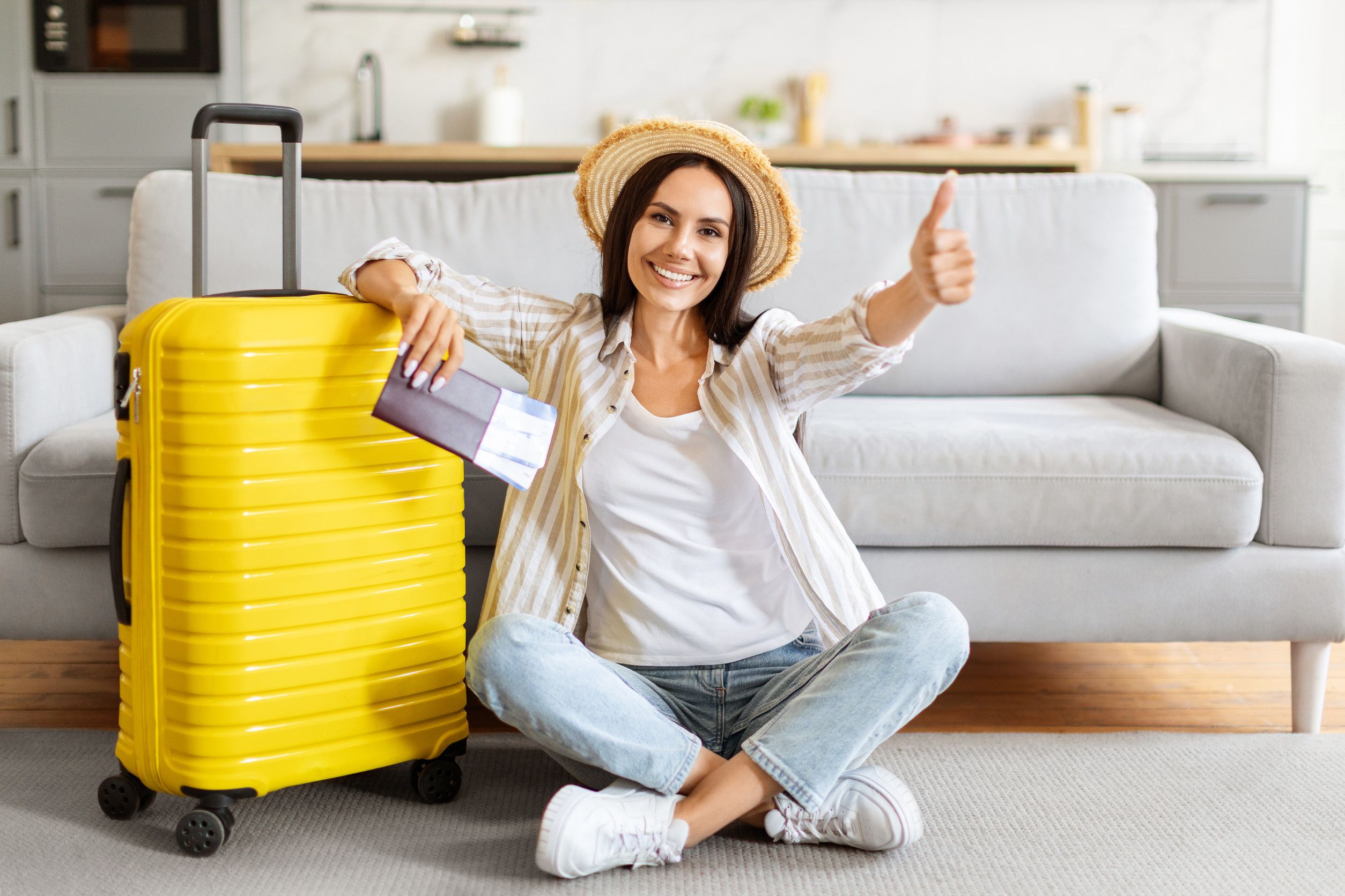 Happy Woman Sitting Near Suitcase Holding Flight Tickets