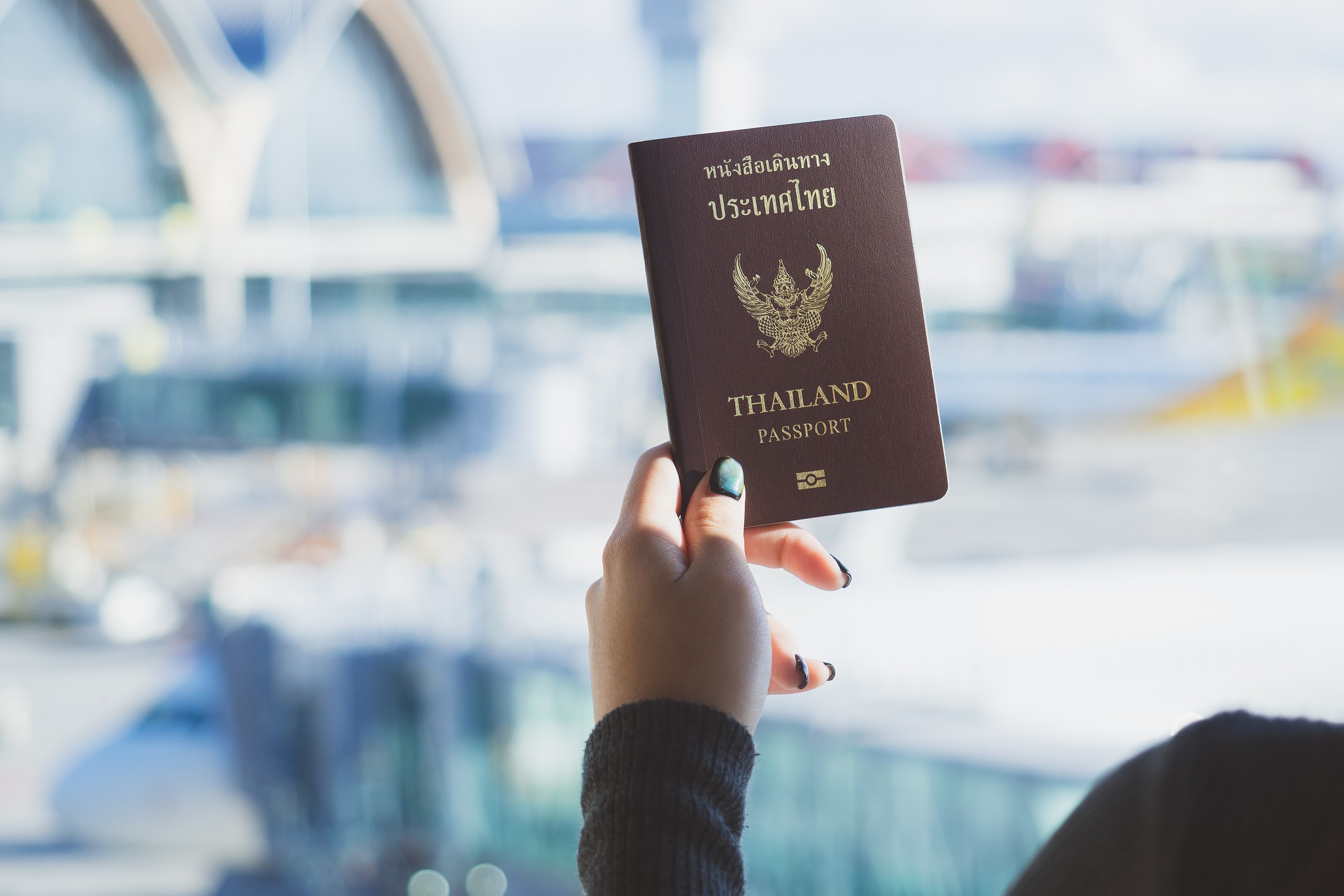Travel Concept Closeup Of Woman Hand Holding Thai Passport Ready To Boarding