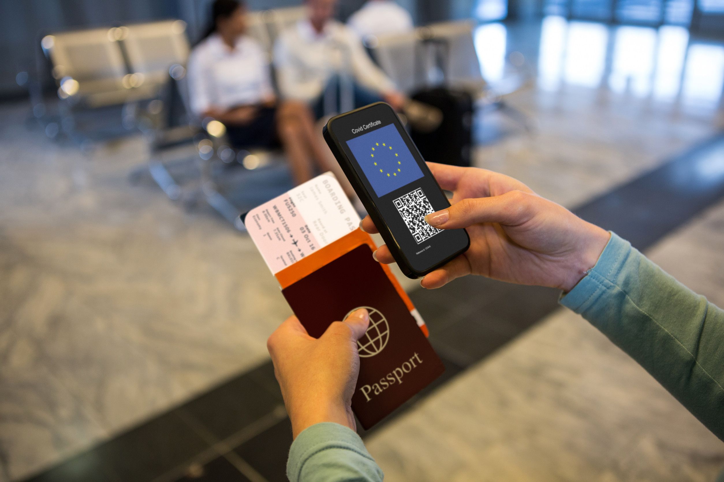 Woman At Airport Holding Documents And Smartphone With Covid